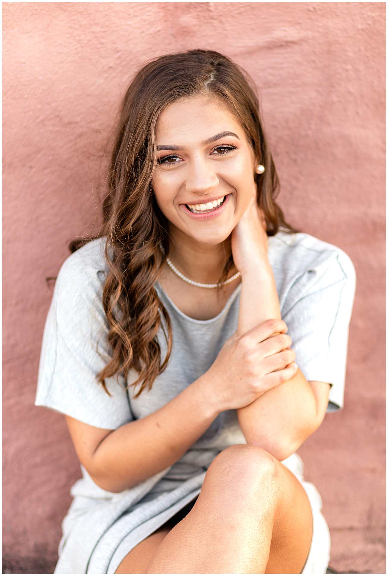 Laughing Spring Senior Photos, Classy Gray Senior Picture Outfit Romper, Pink Wall Senior Portraits